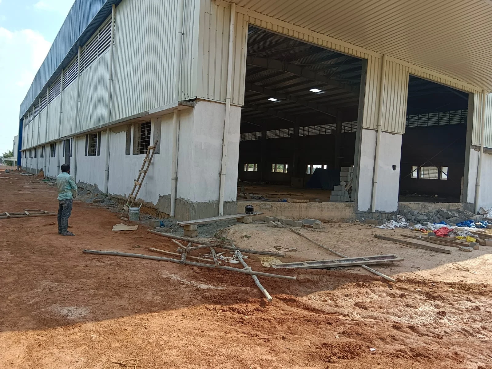 Industrial shed with large open bays and completed masonry