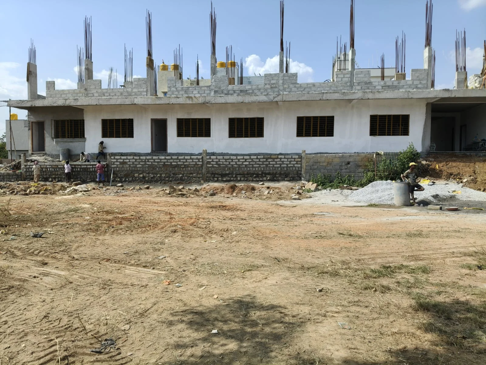 Front view of building construction and boundary masonry work
