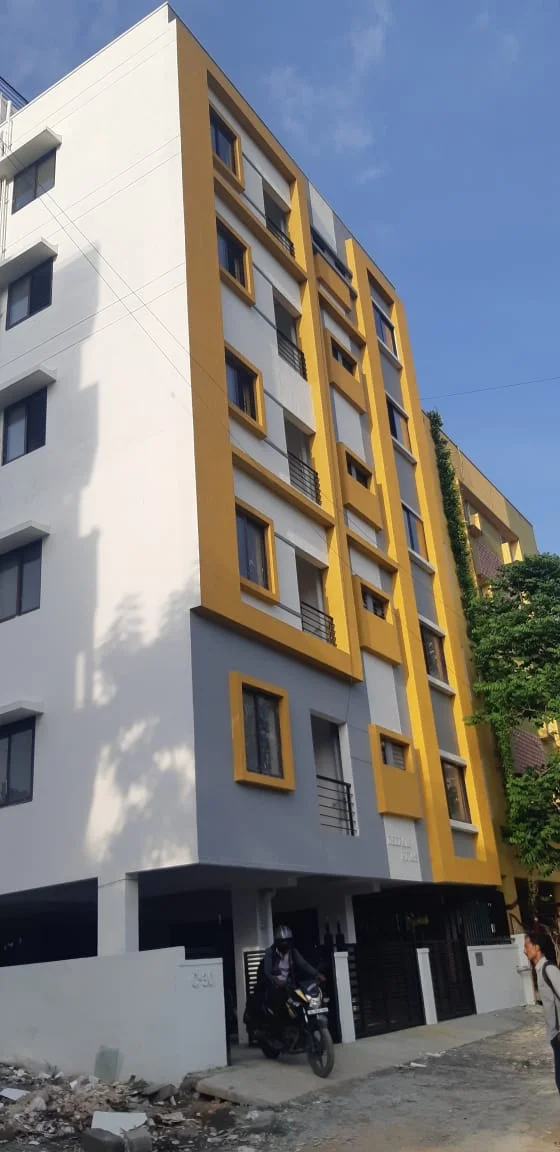 White and yellow multi-storey building exterior viewed from the street