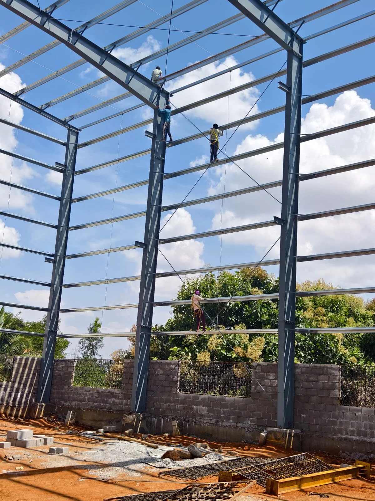 Steel frame erection above the masonry walls