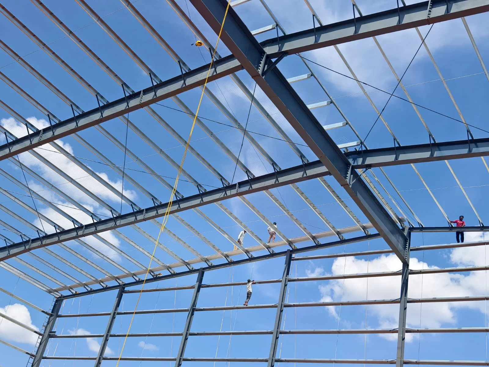 Wide view of steel roof beams and purlins